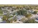 Inviting aerial view of a residential neighborhood with well-maintained homes, lush greenery, and a clear blue pool at 7331 Blue Jacket W Pl, Winter Park, FL 32792
