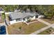 Aerial perspective of the property highlights the home, surrounding trees, and outdoor areas at 7331 Blue Jacket W Pl, Winter Park, FL 32792