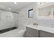 Modern bathroom features sleek marble, glass shower and a vanity with stylish light fixture at 7331 Blue Jacket W Pl, Winter Park, FL 32792