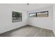 A bright bedroom features sleek wood-look floors and a large window for ample natural light at 7331 Blue Jacket W Pl, Winter Park, FL 32792