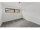 Bright bedroom boasts modern gray flooring, a closet and large windows for ample natural light at 7331 Blue Jacket W Pl, Winter Park, FL 32792
