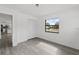 A clean bedroom with gray floors and a closet near the doorway leading to the kitchen at 7331 Blue Jacket W Pl, Winter Park, FL 32792