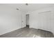 A bright bedroom boasts modern gray flooring and a closet for ample storage space at 7331 Blue Jacket W Pl, Winter Park, FL 32792