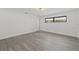 Well-lit bedroom featuring modern flooring and a simple design, ready for personal touches at 7331 Blue Jacket W Pl, Winter Park, FL 32792