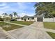 Charming single-story home features a well-maintained lawn, mature trees, and an inviting entrance at 7331 Blue Jacket W Pl, Winter Park, FL 32792