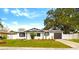 Charming single-story home featuring fresh exterior paint, landscaped yard, and a driveway leading to a one car garage at 7331 Blue Jacket W Pl, Winter Park, FL 32792