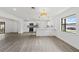 Modern open concept kitchen with hardwood floors, stainless steel appliances, granite countertops and modern lighting at 7331 Blue Jacket W Pl, Winter Park, FL 32792