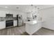 Modern kitchen with stainless steel appliances, stone countertops, and backsplash at 7331 Blue Jacket W Pl, Winter Park, FL 32792