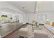 Spacious living room with modern lighting and views into the dining room and back patio at 7331 Blue Jacket W Pl, Winter Park, FL 32792