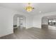 Spacious living area showcasing hardwood floors, modern light fixture, and views of adjacent rooms at 7331 Blue Jacket W Pl, Winter Park, FL 32792
