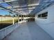 Spacious enclosed patio featuring translucent roofing, concrete floor, and access to the backyard at 7331 Blue Jacket W Pl, Winter Park, FL 32792
