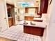 Practical kitchen features wooden cabinets, stainless steel fridge, breakfast bar, and sky light at 8547 Cedar Cove Dr, Orlando, FL 32819