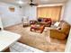 Bright living room featuring plush carpeting, comfortable seating, and a decorative ceiling fan at 8547 Cedar Cove Dr, Orlando, FL 32819
