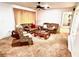 Cozy living room featuring plush carpeting, comfortable seating, and a classic ceiling fan at 8547 Cedar Cove Dr, Orlando, FL 32819