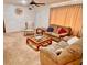 Inviting living room featuring plush carpeting, comfortable seating, and a decorative ceiling fan at 8547 Cedar Cove Dr, Orlando, FL 32819