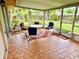 Enclosed patio featuring a tile floor, table and chairs, perfect for enjoying the outdoors at 8547 Cedar Cove Dr, Orlando, FL 32819