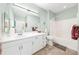 Well-lit bathroom features vanity with sink, mirror, tiled floors, and shower-tub combination at 860 N Orange Ave # 210, Orlando, FL 32801