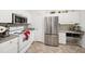 Functional kitchen with stainless steel appliances, white cabinetry, and tile floors at 860 N Orange Ave # 210, Orlando, FL 32801