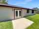 A simple, low maintenance backyard featuring a small concrete patio and fresh green grass at 9744 Tattersall Ave, Orlando, FL 32817