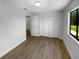 Bedroom features laminate flooring, bright white paint and a large closet at 9744 Tattersall Ave, Orlando, FL 32817