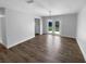 Open dining room with modern light fixture and access to the backyard through sliding glass doors at 9744 Tattersall Ave, Orlando, FL 32817