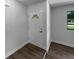 Bright entryway with a white door and decorative window, complemented by wood-look flooring at 9744 Tattersall Ave, Orlando, FL 32817
