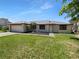 Charming single-story home with a well-manicured lawn and a driveway leading to a two-car garage at 9744 Tattersall Ave, Orlando, FL 32817