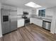 Modern kitchen with stainless steel appliances, granite countertops, and ample cabinet space at 9744 Tattersall Ave, Orlando, FL 32817