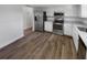 Updated kitchen featuring stainless steel appliances, granite countertops, and white cabinets at 9744 Tattersall Ave, Orlando, FL 32817