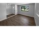 Inviting living room featuring wood-look floors, a bright window, and neutral paint scheme at 9744 Tattersall Ave, Orlando, FL 32817