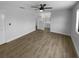 Spacious main bedroom with a ceiling fan, wood-look flooring, and an en-suite bathroom at 9744 Tattersall Ave, Orlando, FL 32817