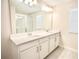 Bathroom featuring double sinks, a large mirror, and ample counter space at 1023 Sugarwood St, Davenport, FL 33837