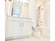 Pristine bathroom with white vanity, shower, and tiled floors, exuding cleanliness and functionality at 1023 Sugarwood St, Davenport, FL 33837