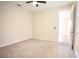 Comfortable bedroom featuring neutral carpeting, ceiling fan, and ample natural light from the window at 1023 Sugarwood St, Davenport, FL 33837