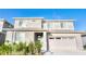 Charming two-story home featuring a two-car garage, well-manicured landscaping, and a welcoming front entrance at 1023 Sugarwood St, Davenport, FL 33837