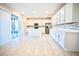 Modern kitchen featuring white cabinetry, stainless steel appliances, and a large island with seating at 1023 Sugarwood St, Davenport, FL 33837