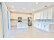 Bright kitchen with ample counter space, stainless steel appliances, and a view to the backyard through sliding doors at 1023 Sugarwood St, Davenport, FL 33837