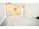 Bright, open living room with plush carpeting, ideal for entertaining and relaxation at 1023 Sugarwood St, Davenport, FL 33837