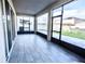 Spacious enclosed patio with sliding glass windows, offering panoramic views of the backyard and surrounding landscape at 1023 Sugarwood St, Davenport, FL 33837