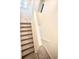 Carpeted stairs with white banister, showcasing modern design and functionality at 1023 Sugarwood St, Davenport, FL 33837