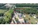 Aerial view of a home with a driveway, surrounded by trees, and a defined property outline at 10750 Sw 110Th St, Dunnellon, FL 34432