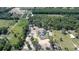 Aerial view of a home with a circular driveway, surrounded by trees, and bordering an agricultural space at 10750 Sw 110Th St, Dunnellon, FL 34432