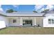 Back porch with stone columns, ceiling fans, concrete floor, and a large window with a backyard view at 10750 Sw 110Th St, Dunnellon, FL 34432