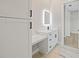 Contemporary bathroom featuring modern vanity with backlit mirror and storage at 10750 Sw 110Th St, Dunnellon, FL 34432