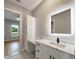 Stylish bathroom featuring vanity with modern lit mirror, seating, and storage at 10750 Sw 110Th St, Dunnellon, FL 34432