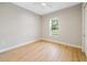Bright bedroom with wood floors, neutral walls, and a view of the outdoors at 10750 Sw 110Th St, Dunnellon, FL 34432