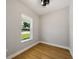 Cozy bedroom with a large window offering ample natural light and plank floors at 10750 Sw 110Th St, Dunnellon, FL 34432