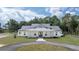 Stunning single-story home featuring a welcoming front porch and circular driveway at 10750 Sw 110Th St, Dunnellon, FL 34432