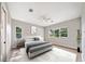 Stylized main bedroom with plank floors and several windows offering natural light and outside views at 10750 Sw 110Th St, Dunnellon, FL 34432