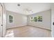 Bright main bedroom with plank floors and several windows offering natural light and outside views at 10750 Sw 110Th St, Dunnellon, FL 34432